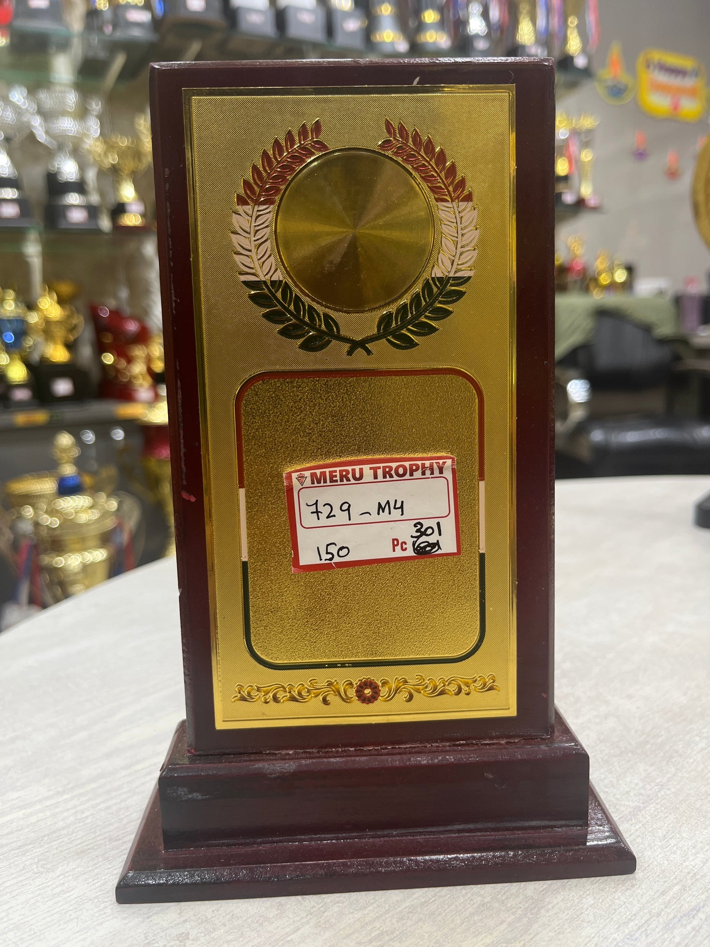 Wooden memento with gold foil and India flag design for employee awards.