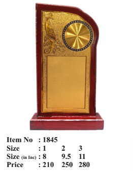 Close-up of a wooden memento featuring a gold plate and peacock design; perfect for corporate trophy.