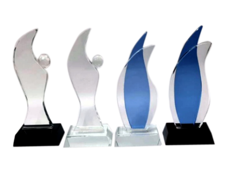 Set of four glass awards with varying designs on a white background