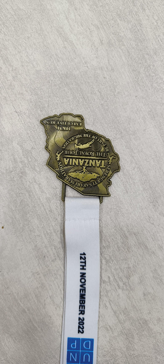 Tanzania Marathon custom medal with lanyard; commemorating the 2022 event. Ideal for sports prizes or corporate awards.